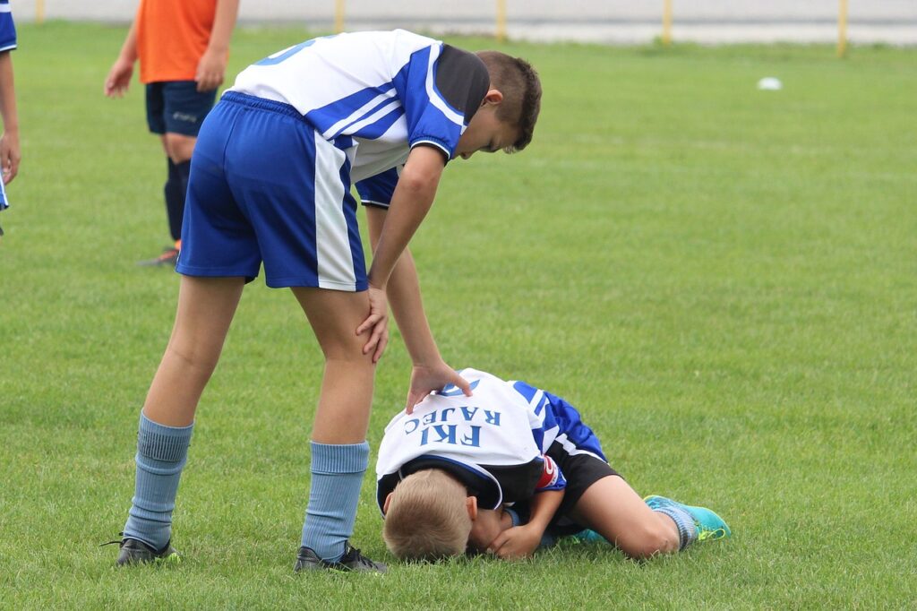 Soccer player injured, sports first responder to care and manage these injuries