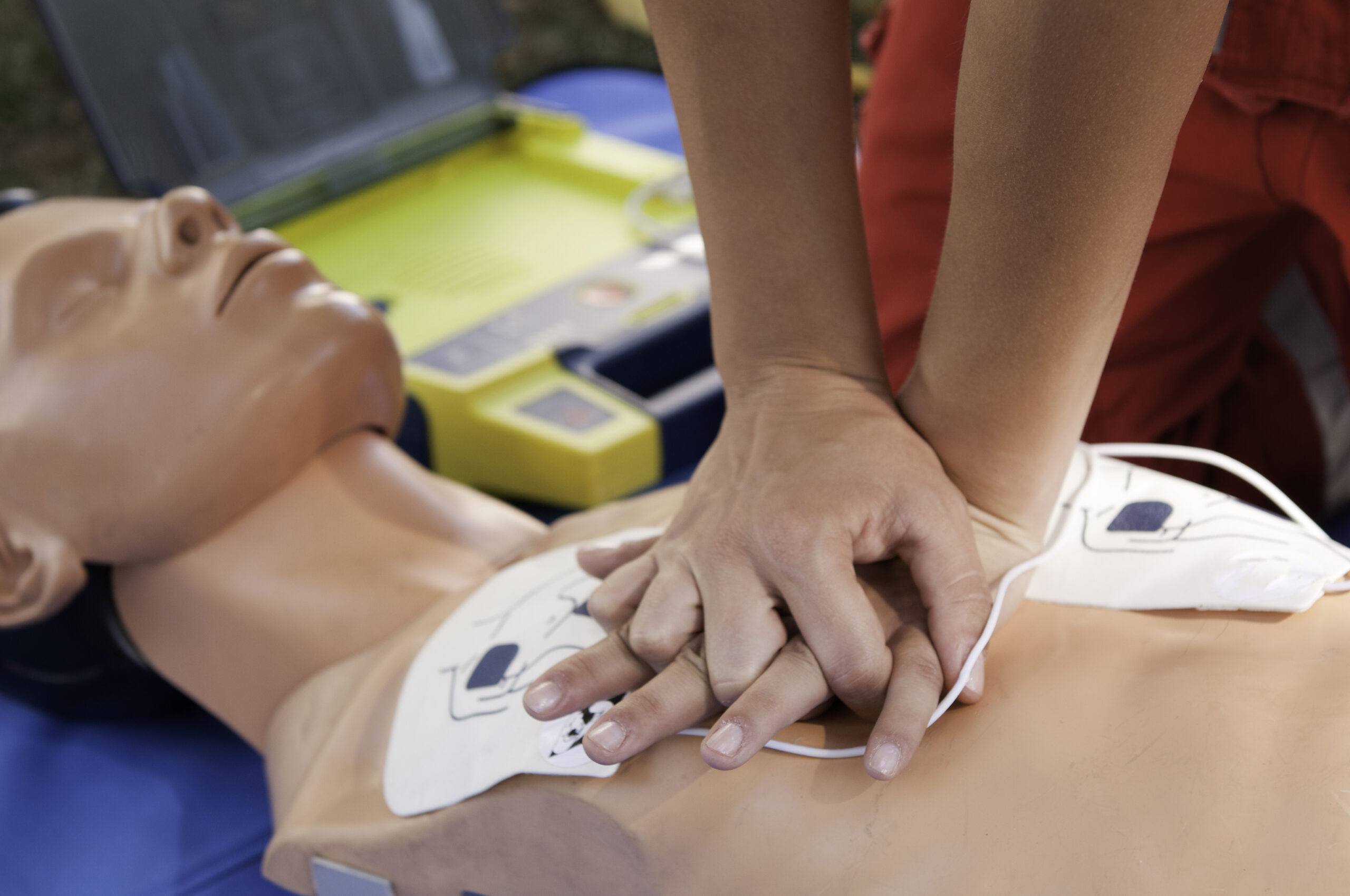 Person performing CPR on a manikin during CPR training