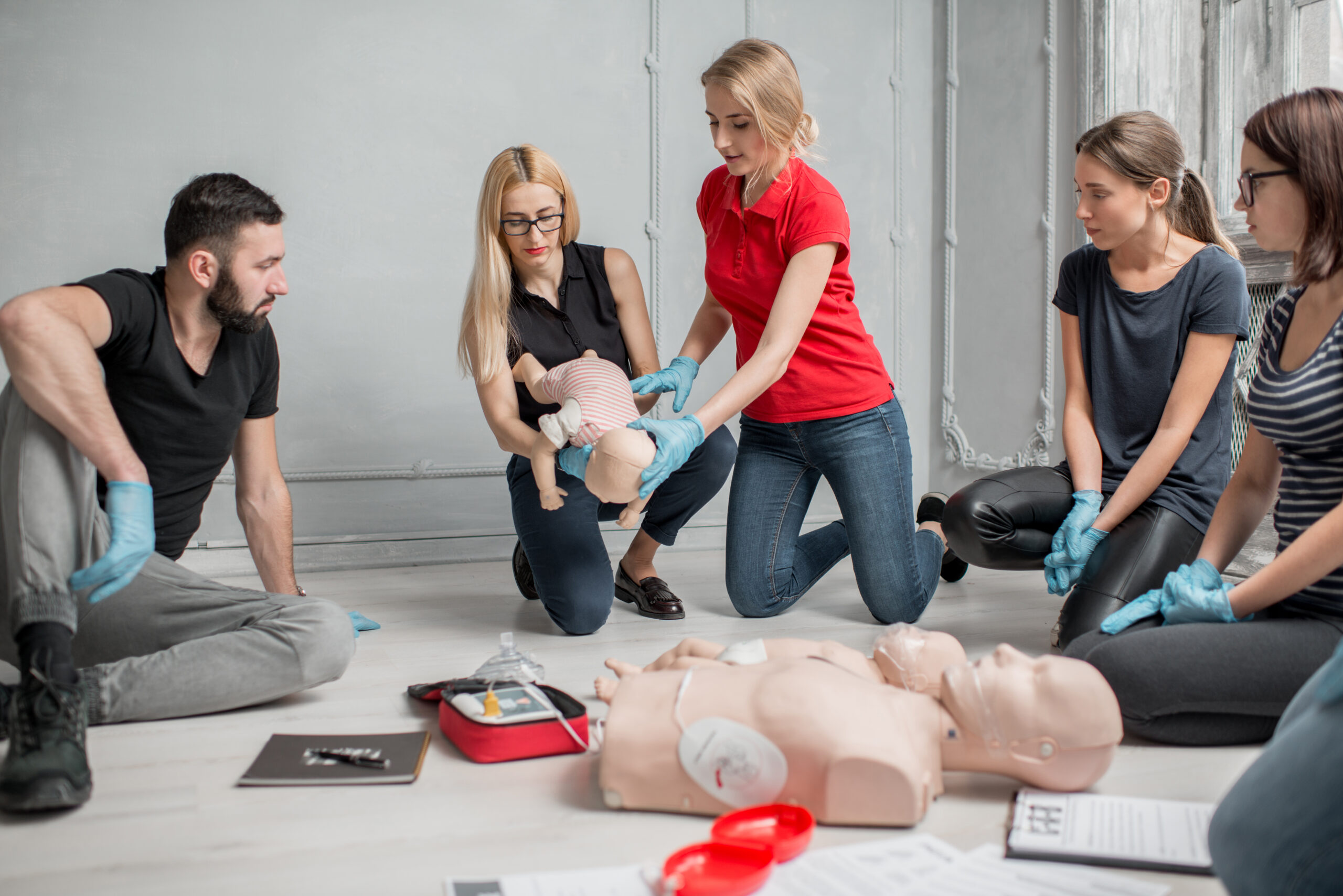 Instructor demonstrating choking in a standard first aid training course